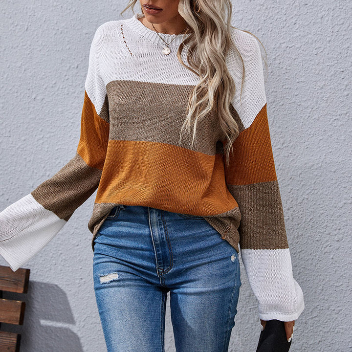 Woman wearing color-block sweater in white, brown, and mustard tones