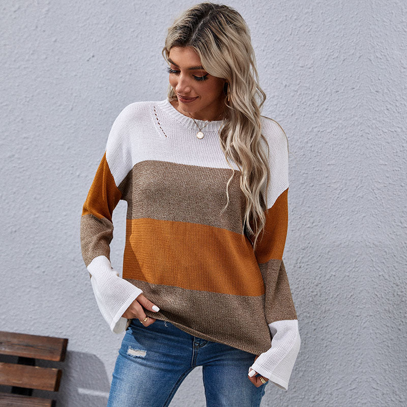 Woman wearing color-block sweater in white, brown, and mustard tones
