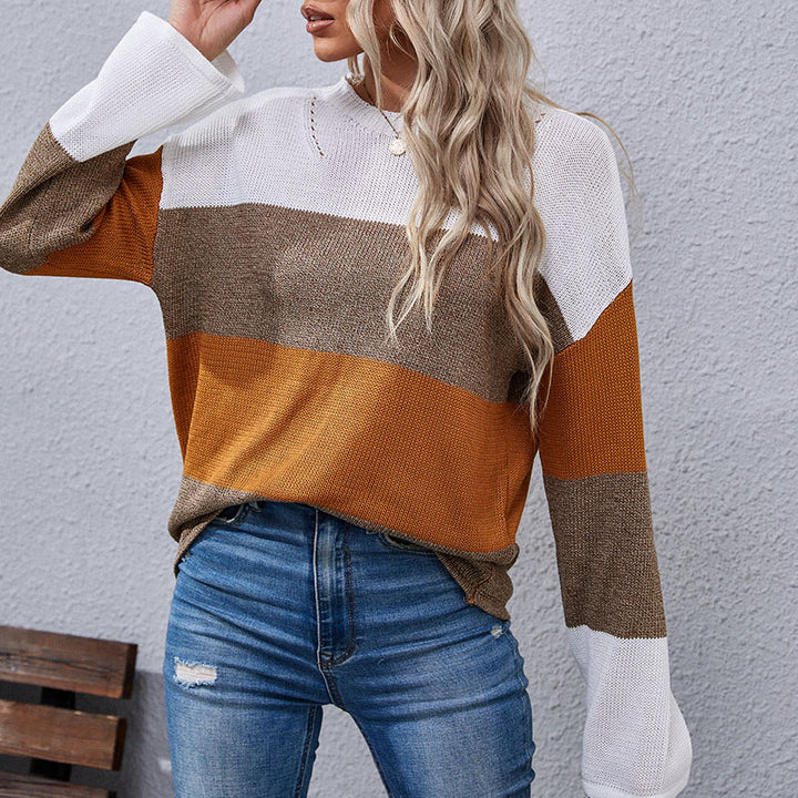 Woman wearing color-block sweater in white, brown, and mustard tones