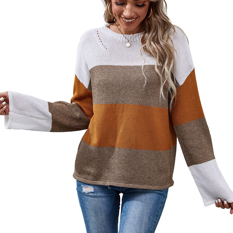 Woman wearing color-block sweater in white, brown, and mustard tones