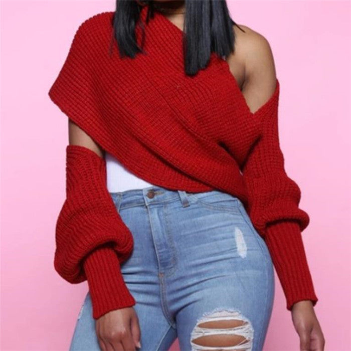 Female model wearing red cut-out shoulder knit sweater and blue jeans