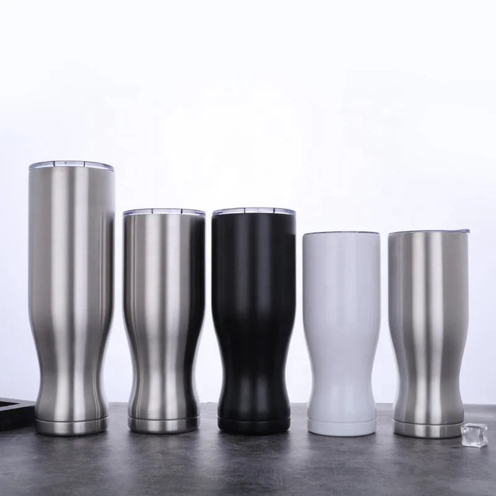  Insulated tumblers in different colors on a reflective surface with a light gray background