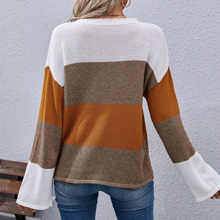 Woman wearing color-block sweater in white, brown, and mustard tones